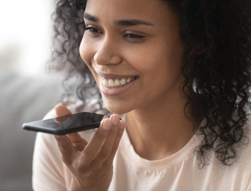 woman smiling and holding phone