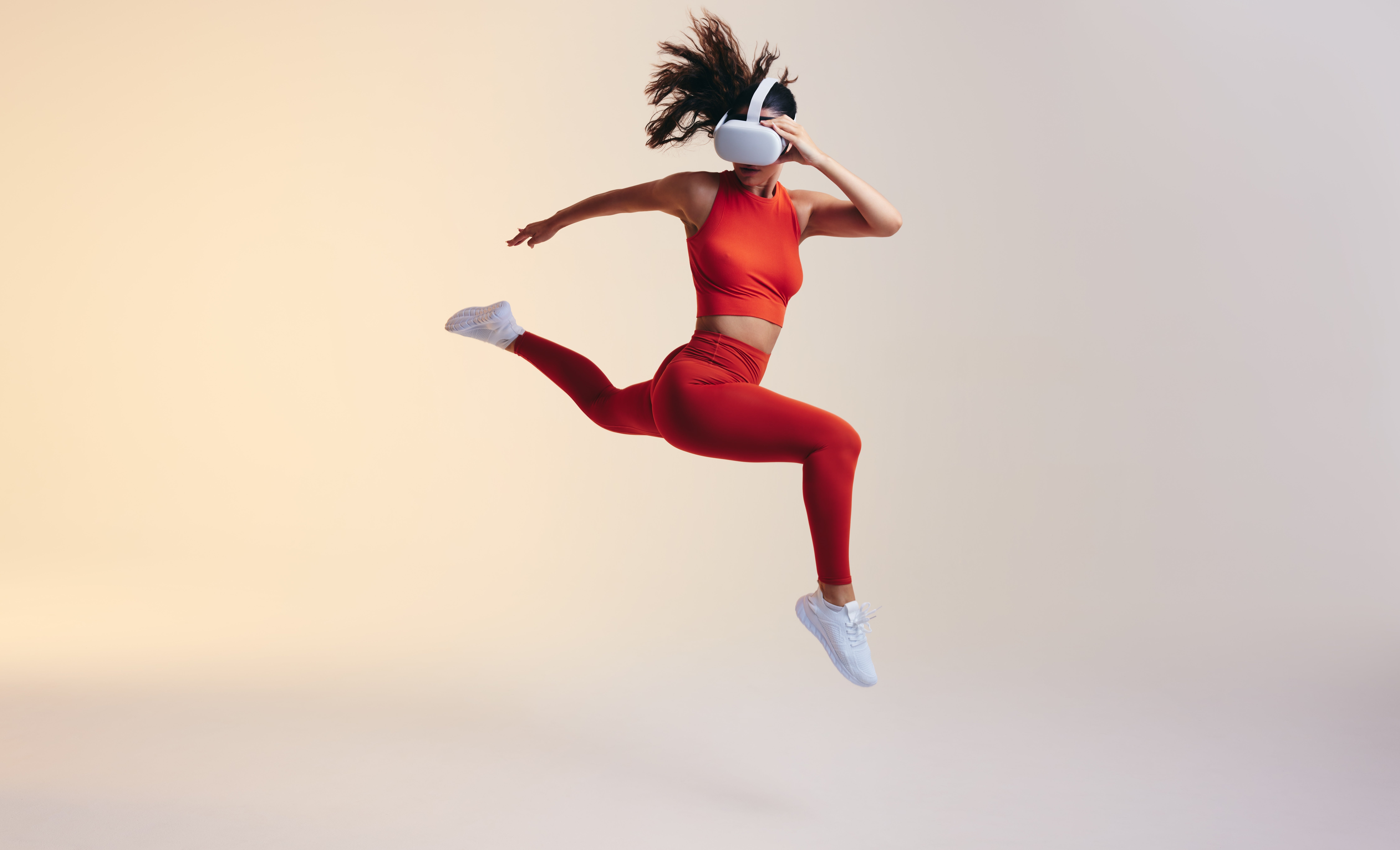 photo of individual, white skin, with virtual reality glasses on, leaping