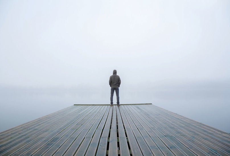 person standing on the end of a dock