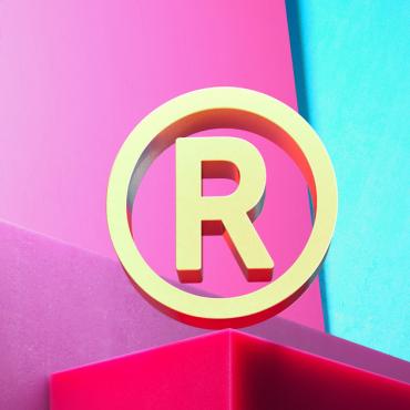 3D illustration of golden registered icon on magenta and cyan geometric background.