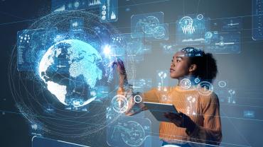 African American businesswoman using virtual technology of a blue globe and tech interface.