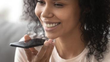 woman smiling and holding phone