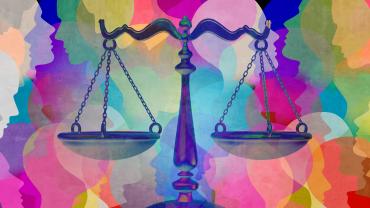 scales of justice with rainbowcolored faces behind it