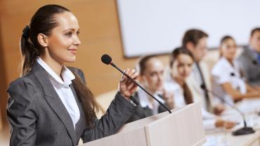 woman standing at the podium ready to speak