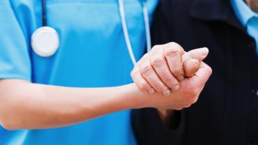 nurse and colleague shaking hands