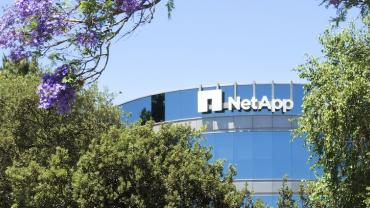 photo of NetApp headquarters building façade framed by trees
