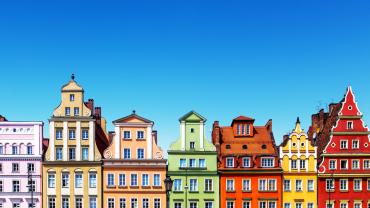 townhouses in Poland each painted as one color of the rainbow in descending order