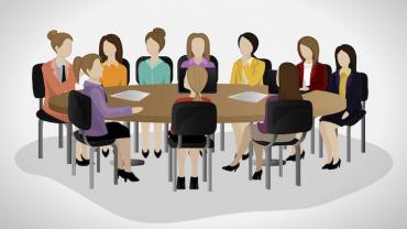 a group of business women at a conference table